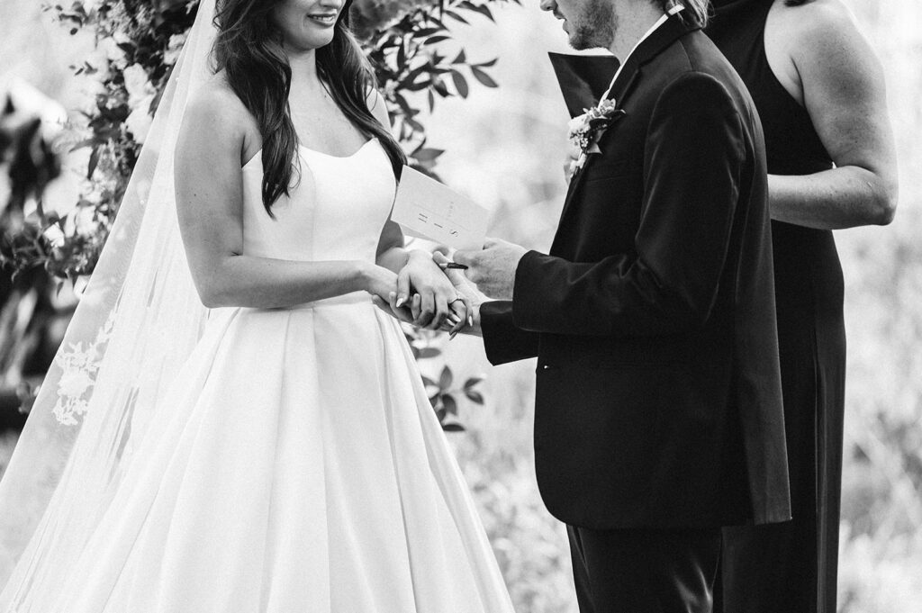 bride and groom holding hands during vows