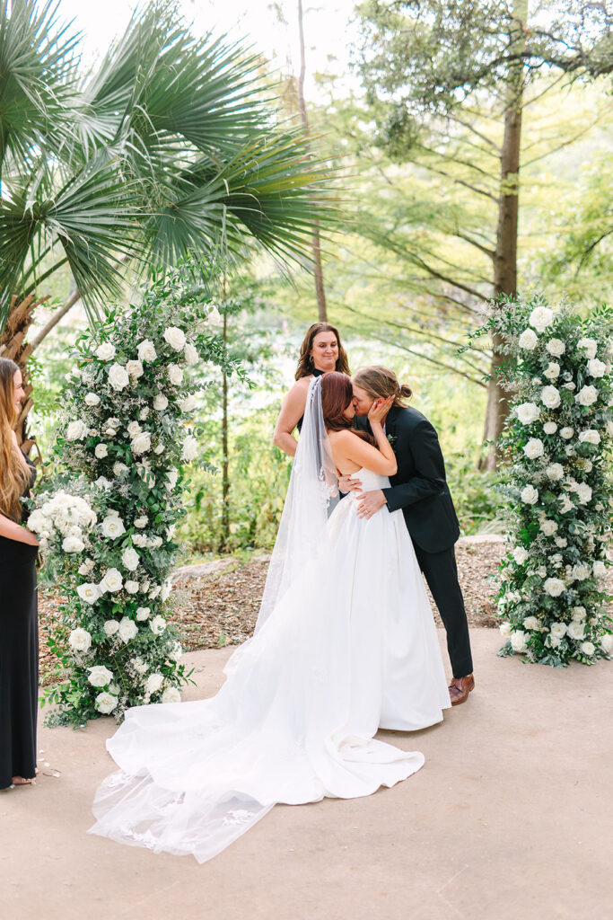 bride and groom kissing during wedding ceremony