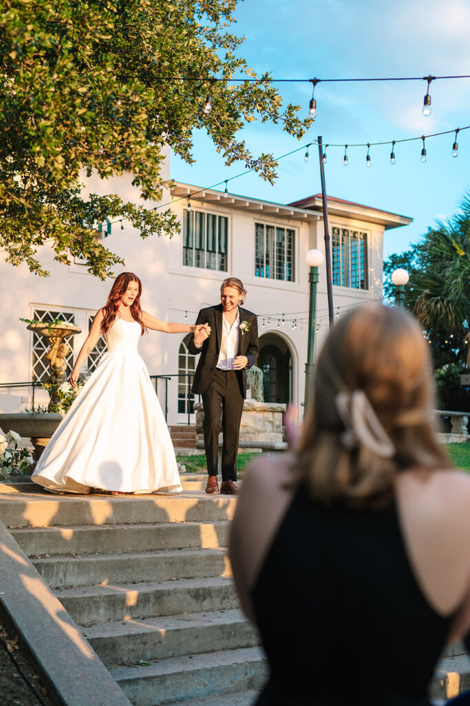 bride and groom entering wedding reception