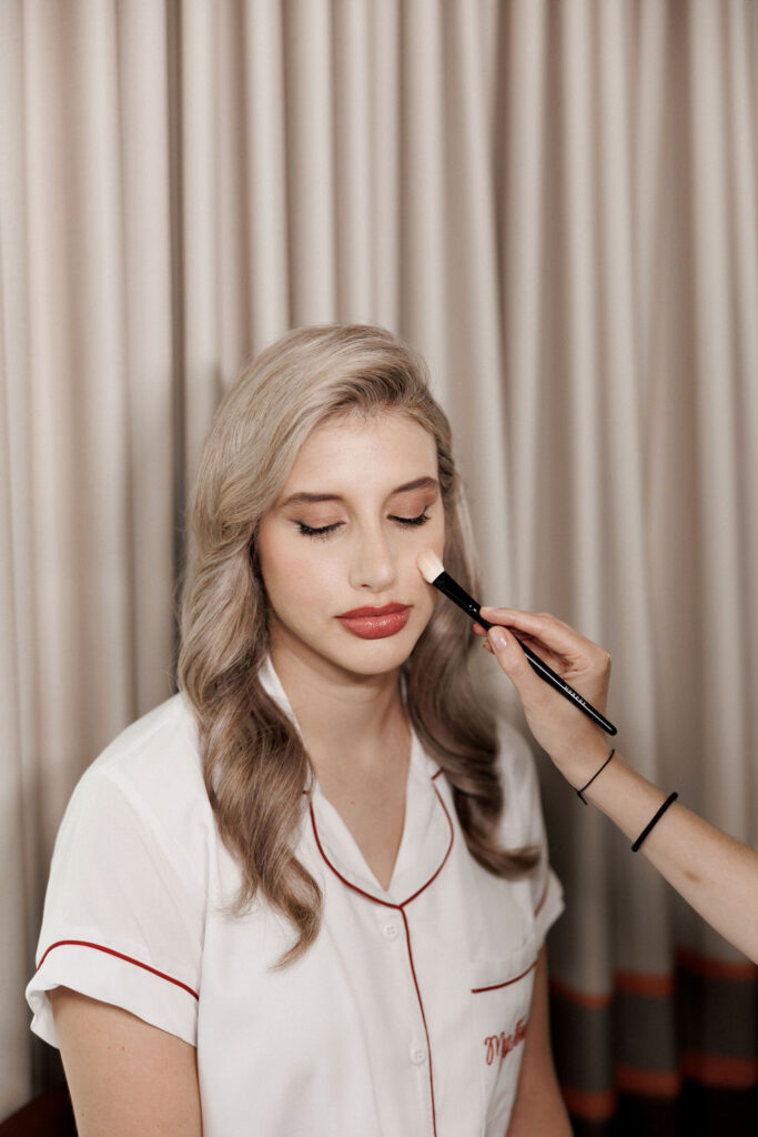 bride getting makeup done