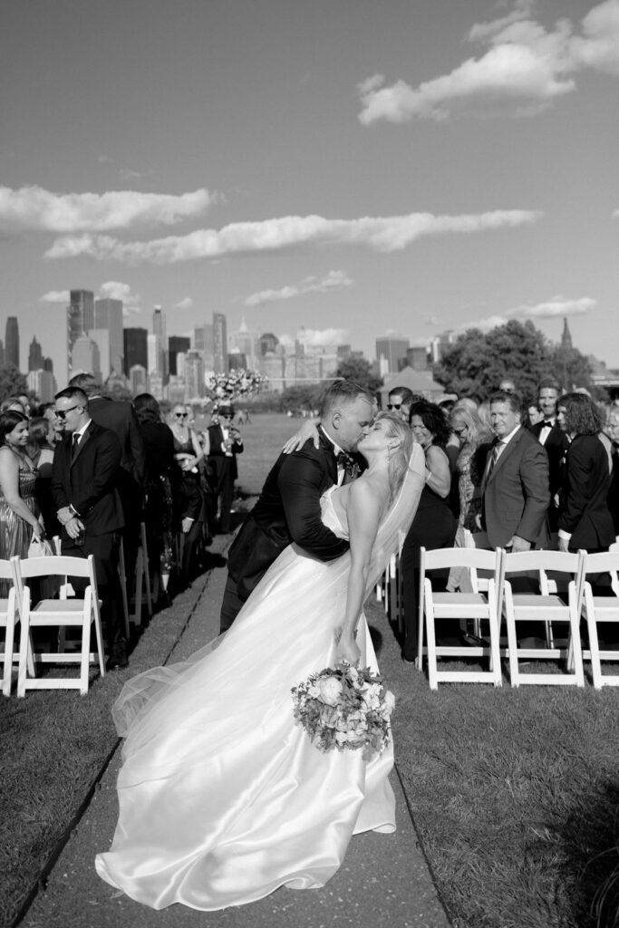 bride and groom kissing in the aisle